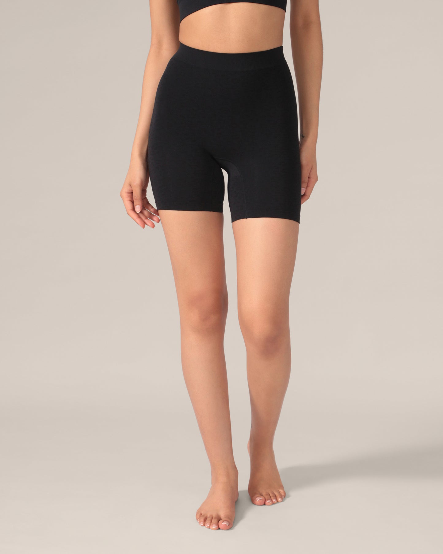 Person wearing black high-waisted undershorts with a leopard pattern